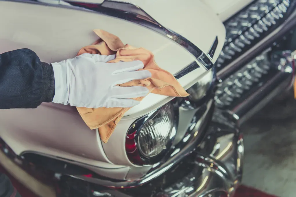 Taking Care of Classic Car. Passionate Vintage Cars Collector Cleaning One of His Vehicle. Closeup Photo.